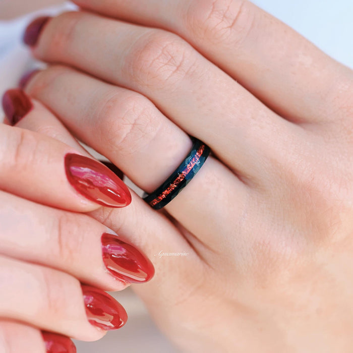 Crushed Red Garnet Couples Ring Set featuring a black tungsten band with vibrant crushed red garnet inlay, showcased on hand with matching red nail polish by Aquamarise.