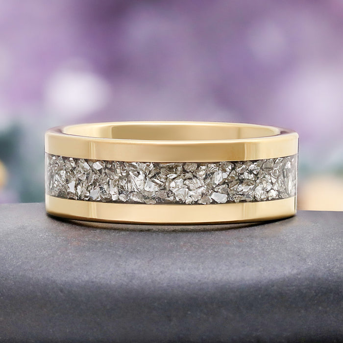 Close-up of the crushed simulated diamond inlay set flush between polished gold tungsten rails
