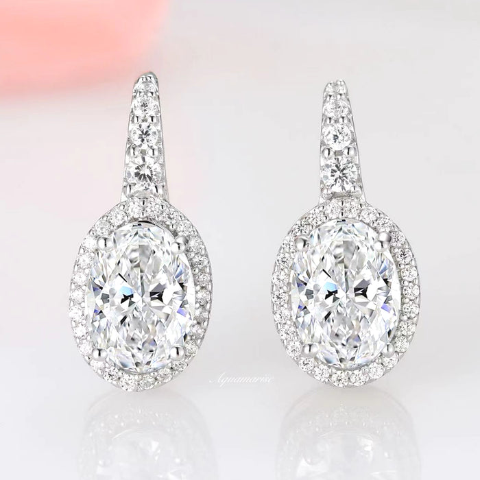 Simulated Diamond Dangle Earrings in Sterling Silver by Aquamarise, featuring oval cubic zirconia surrounded by sparkling stones on a polished drop setting with elegant refinement.