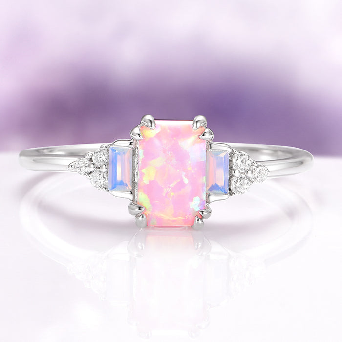 Dainty Pink Fire Opal Ring in Sterling Silver by Aquamarise, featuring a rectangular pink fire opal center with shimmering opalescent sapphires and delicate diamond accents on a slender sterling silver band, part of Sterling Silver Rings and October Birthstone collections.