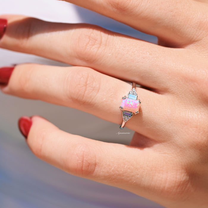 Dainty Pink Fire Opal Ring in Sterling Silver by Aquamarise, featuring a rectangular pink fire opal centerpiece with opalescent sapphire accents on a sleek sterling silver band, part of Sterling Silver Rings and October Birthstone collections.
