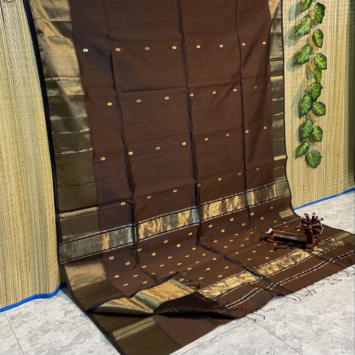 Dark brown Maheshwari silk saree with small gold buti and a prominent wide gold geometric border, handwoven in Maheshwar