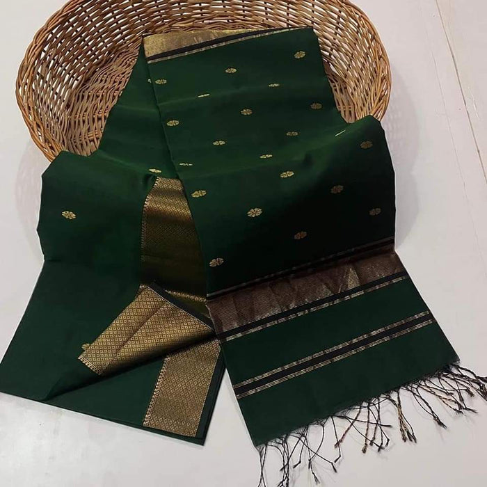Handloom Maheshwari silk saree in dark green, flower buti scattered across the body, with a wide golden zari border