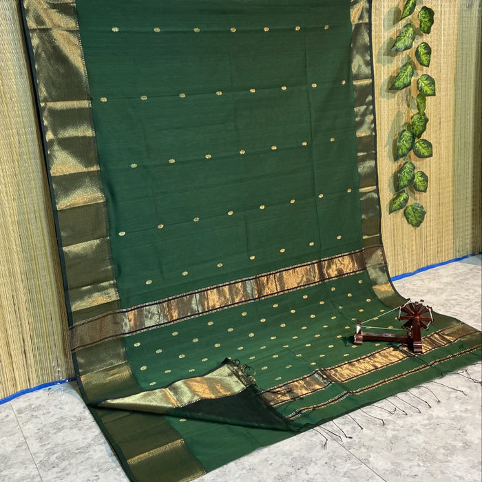 Handloom Maheshwari silk saree in dark green, flower buti scattered across the body, with a wide golden zari border