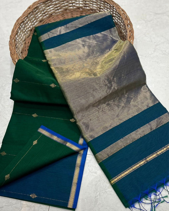 Dark green Maheshwari silk saree with small dobby-set buti and a deep teal pallu banded in metallic stripes, handwoven in Maheshwar