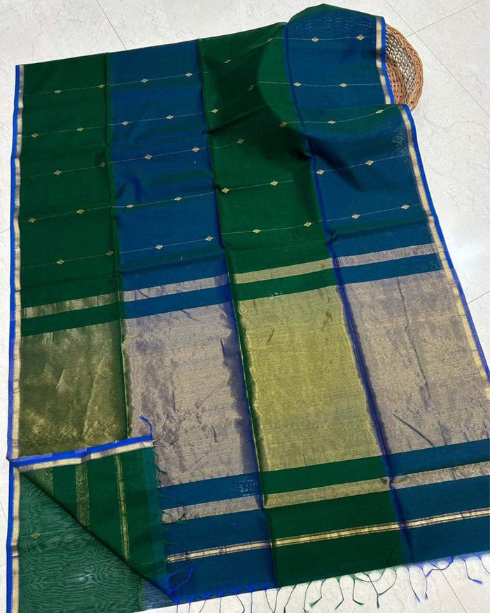 Dark green Maheshwari silk saree with small dobby-set buti and a deep teal pallu banded in metallic stripes, handwoven in Maheshwar