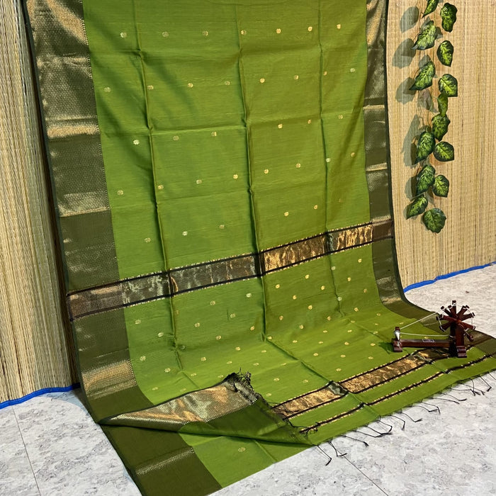 Handloom Maheshwari silk saree in dark olive green, flower buti scattered across the body, with a wide golden zari border
