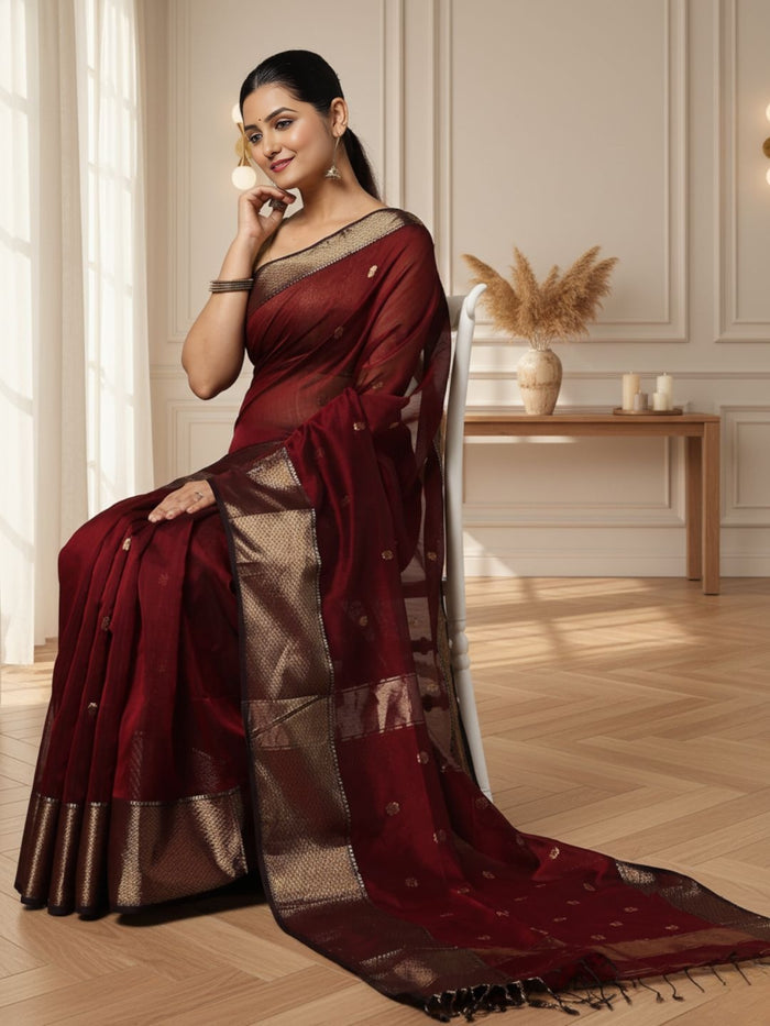 Dark red Maheshwari silk saree with a butta body of small buti and wide antique gold and brown borders, handwoven in Maheshwar