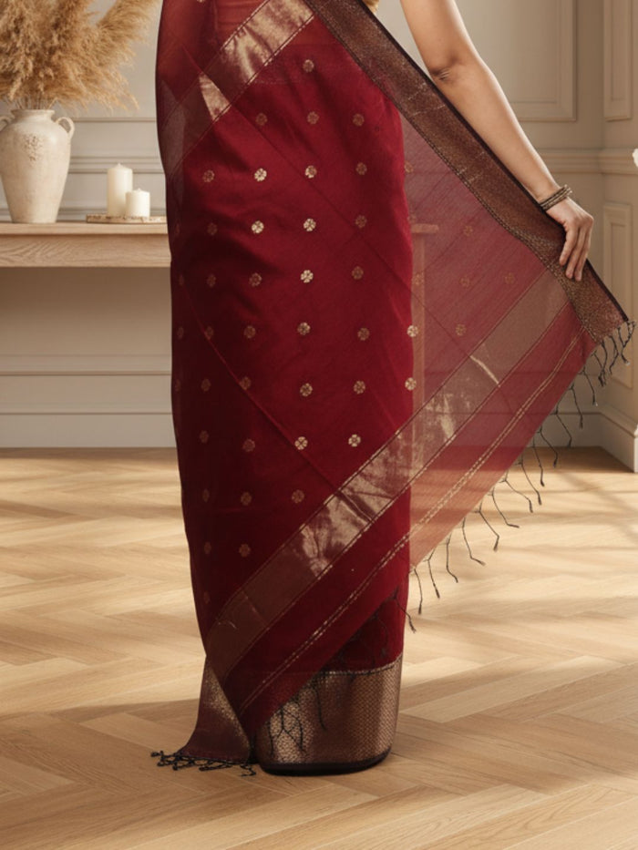Dark red Maheshwari silk saree with a butta body of small buti and wide antique gold and brown borders, handwoven in Maheshwar