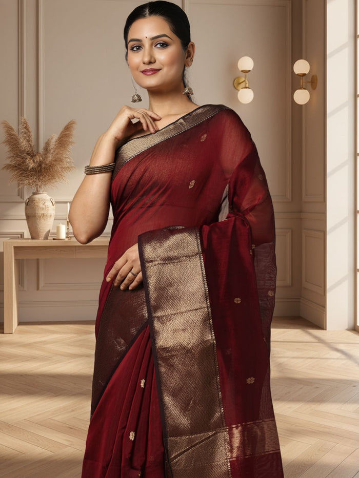 Dark red Maheshwari silk saree with a butta body of small buti and wide antique gold and brown borders, handwoven in Maheshwar