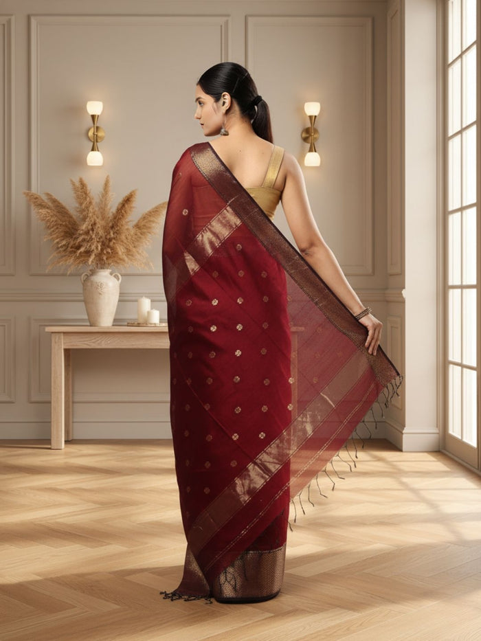 Dark red Maheshwari silk saree with a butta body of small buti and wide antique gold and brown borders, handwoven in Maheshwar