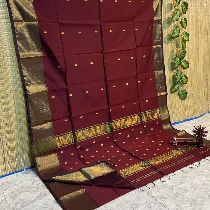 Dark red Maheshwari silk saree with a butta body of small buti and wide antique gold and brown borders, handwoven in Maheshwar