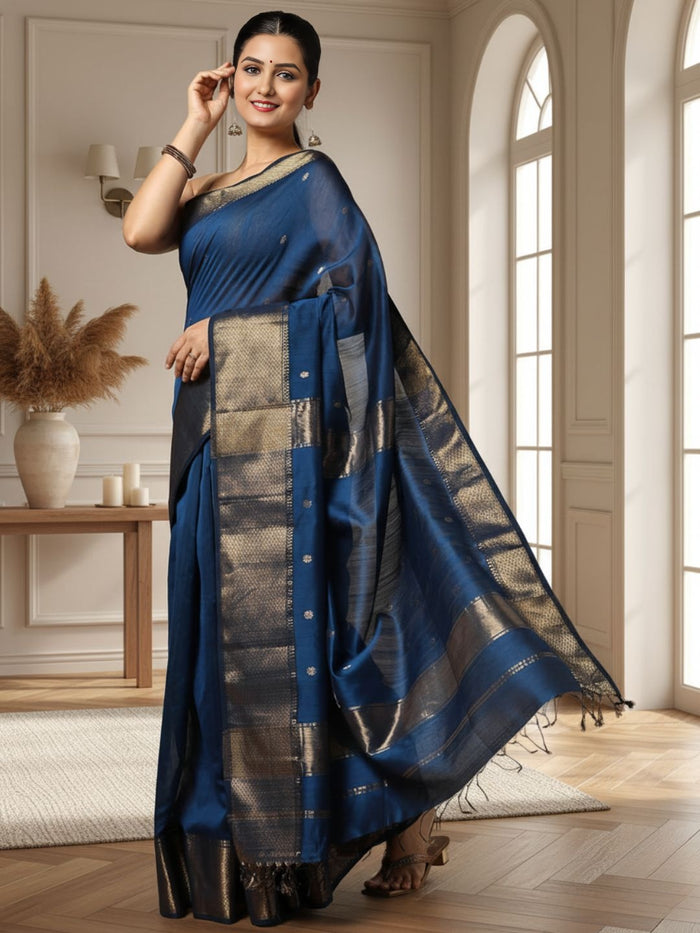 Handloom Maheshwari silk saree in deep blue, flower buti scattered across the body, with a wide golden zari border