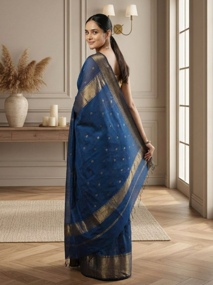 Handloom Maheshwari silk saree in deep blue, flower buti scattered across the body, with a wide golden zari border