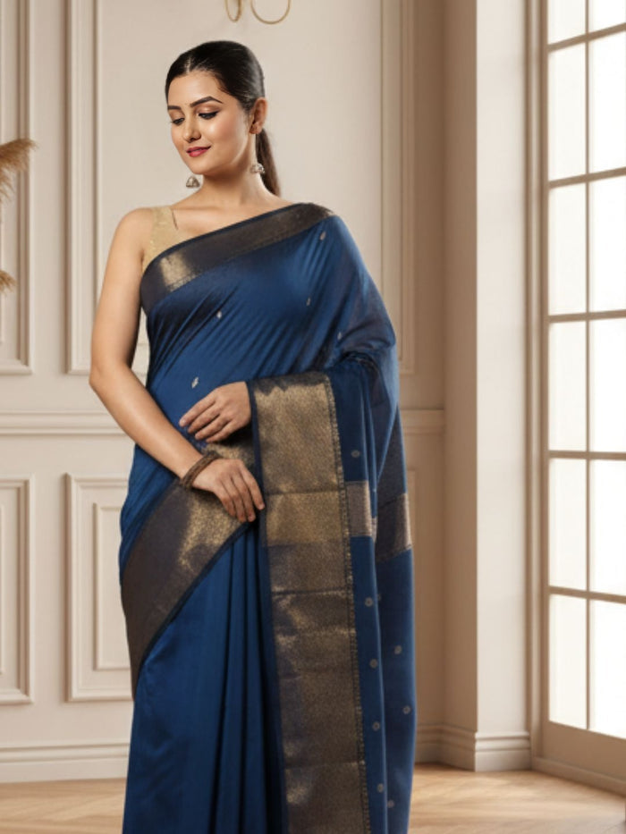 Handloom Maheshwari silk saree in deep blue, flower buti scattered across the body, with a wide golden zari border