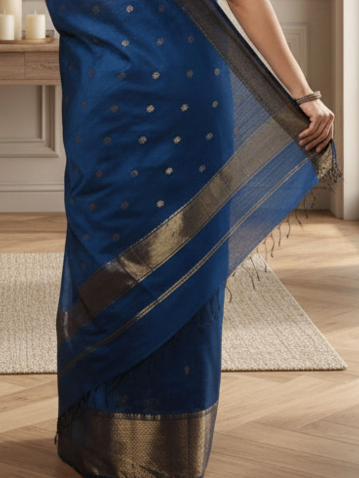 Handloom Maheshwari silk saree in deep blue, flower buti scattered across the body, with a wide golden zari border