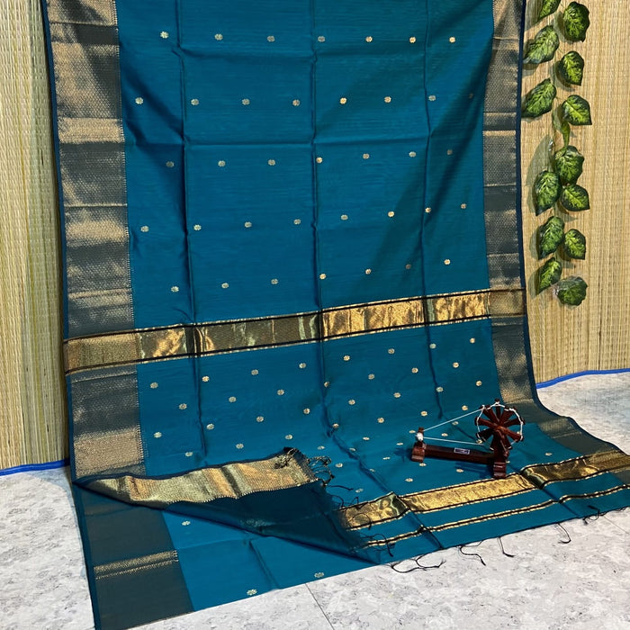 Handloom Maheshwari silk saree in deep blue, flower buti scattered across the body, with a wide golden zari border