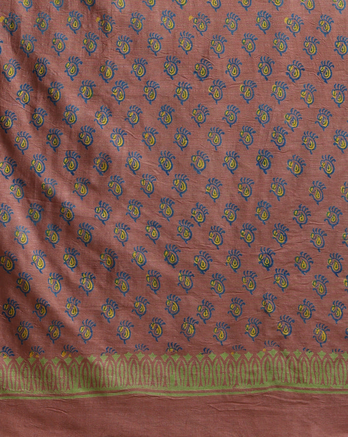 Deep blue katan silk unstitched suit with all-over block-printed floral and diamond motifs, a rust-orange dupatta with wide geometric end borders, and a plain blue bottom.