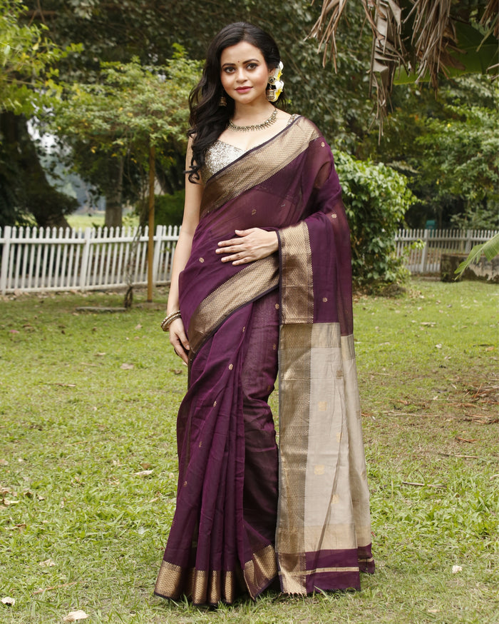 Handloom Maheshwari silk saree, deep purple body with flower buti, beige pallu with lotus buti and a golden zari border
