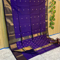 Deep purple Maheshwari silk saree with small gold buti across the body and wide metallic gold borders, handwoven in Maheshwar