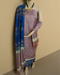 Unstitched katan silk suit set colour blocked in dusty rose and blue, with hand block printed botanical and star-like geometric bands in white and gold.