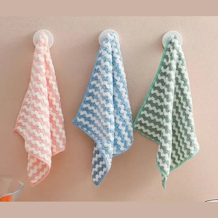 Eco-friendly microfiber dishcloths hanging in pastel colors for a stylish, organized kitchen.