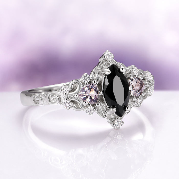 Elain Black Onyx Couples Ring Set featuring a marquise black onyx center stone with intricate silver scrollwork and sparkling accent gemstones by Aquamarise.