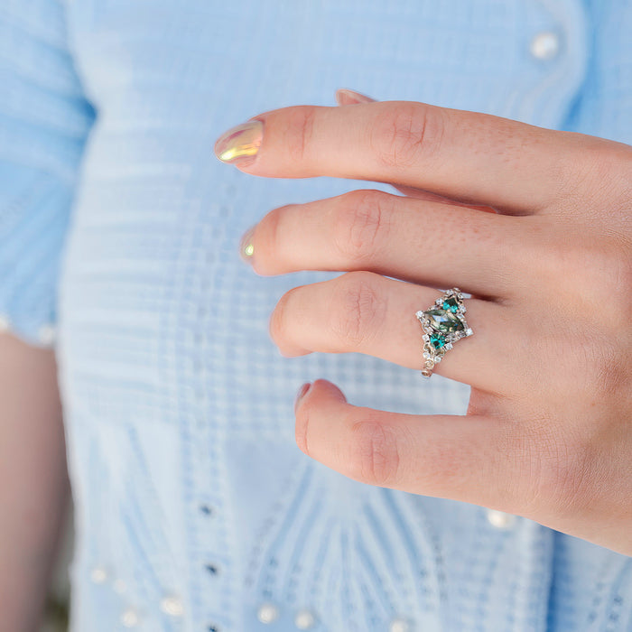 Elain Moss Agate & Teal Sapphire Leaf Ring- 14K White Gold featuring a marquise-cut green moss agate surrounded by teal sapphires set on a delicate white gold band by Aquamarise Gold, inspired by nature and fantasy.