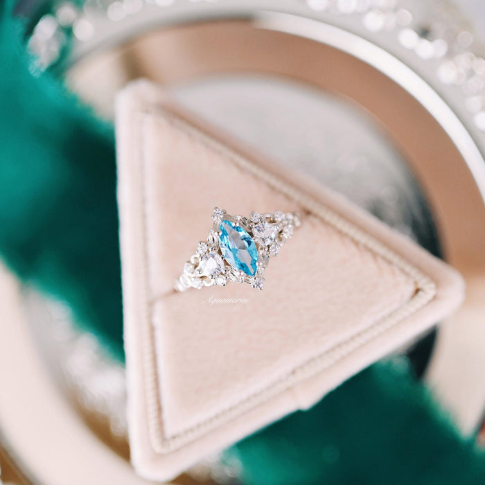 Elain Swiss Blue Topaz Leaf Engagement Ring in 14K White Gold by Aquamarise Gold, showcasing a marquise-cut Swiss Blue Topaz center stone with delicate diamond accents set on a nature-inspired band, part of Solid Gold Engagement Rings and November Birthstone collections.