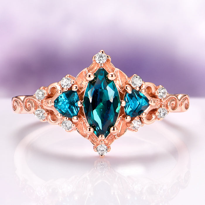 Elain Teal Sapphire Fairy Engagement Ring in 14K Rose Gold Vermeil featuring a marquise teal sapphire center with diamond accents in a nature-inspired rose gold setting by Aquamarise.
