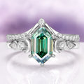 Elara Pacific Green Moissanite & Crescent Moon Engagement Ring Set in 14K White Gold by Aquamarise Gold features a stunning hexagonal green moissanite center stone framed by crescent moon and diamond accents, crafted with celestial elegance.