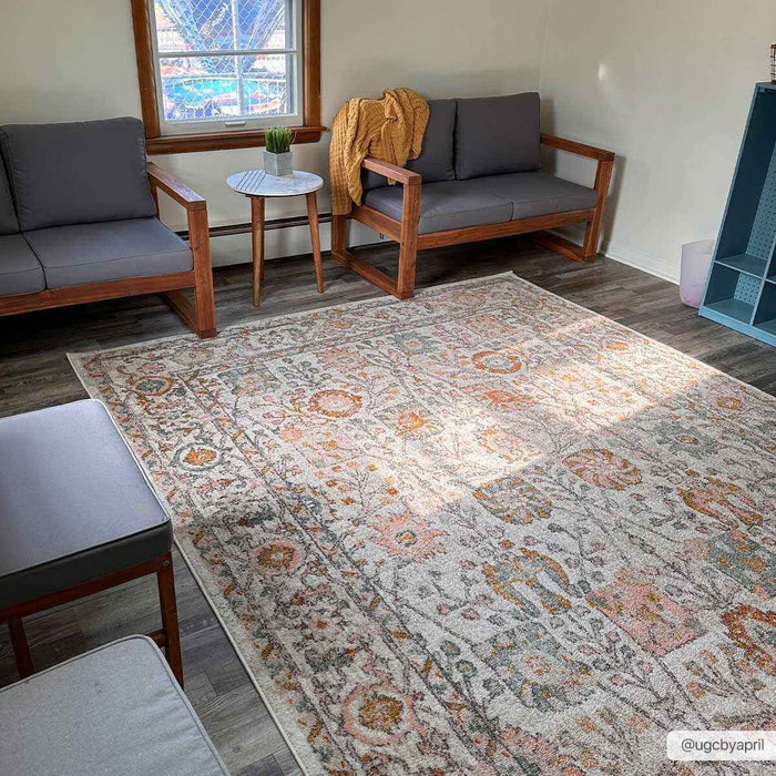 Herstmonceux elegant area rug displayed in a cozy living room with modern seating and natural lighting.