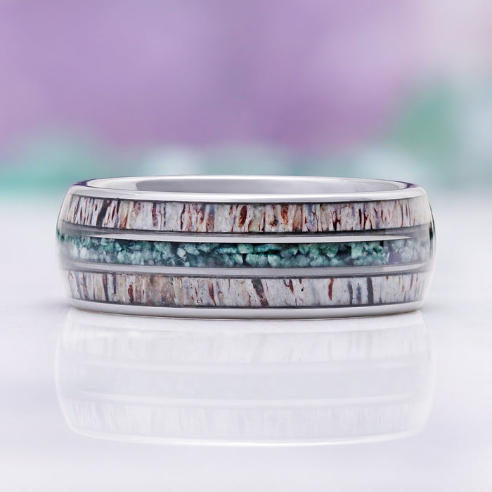 Side profile of the antler and moss agate inlays framed by polished silver tungsten edges