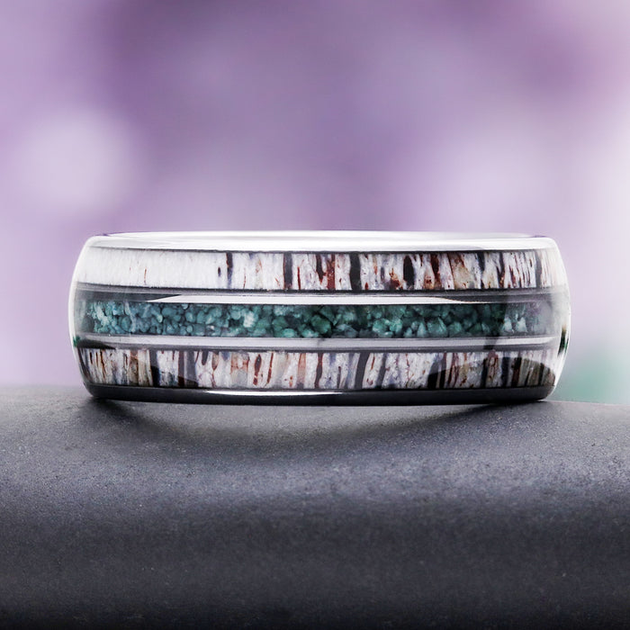 Elk antler wedding band on slate, showing the twin antler inlays and central moss agate channel
