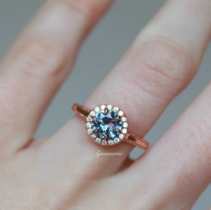 Ella Alexandrite Engagement Ring in 14K Solid Rose Gold by Aquamarise Gold showcases a sparkling round alexandrite center stone framed by a delicate halo of diamonds on a finely crafted rose gold band, part of Solid Gold Engagement Rings and June Birthstone Jewelry collections.