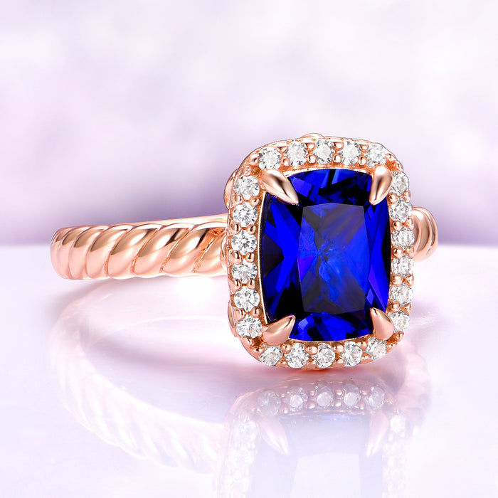 Blue Sapphire Engagement Ring Cushion Cut Ceylon Sapphire on hand over light purple background