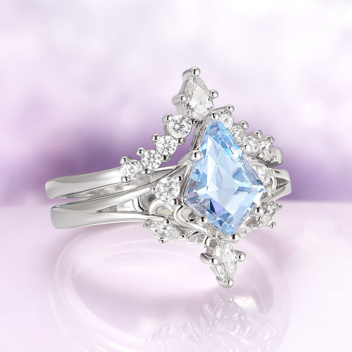 Elegant aquamarine ring with a pear-shaped blue gemstone on a soft purple background