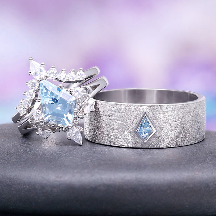 Two silver rings with blue gemstones on a gray surface with a blurred purple background
