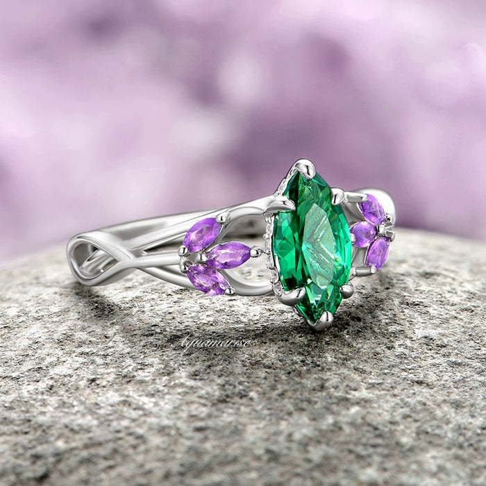 Emerald & Amethyst Mystical Fairy Ring- 14K White Gold featuring a marquise emerald centerpiece surrounded by marquise amethyst accents on a twisted white gold band, crafted by Aquamarise Gold from fantasy-inspired and nature-inspired engagement ring collections.