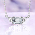 Emerald cut moissanite necklace in sterling silver, 6x8mm center stone set east-west with round moissanite accents