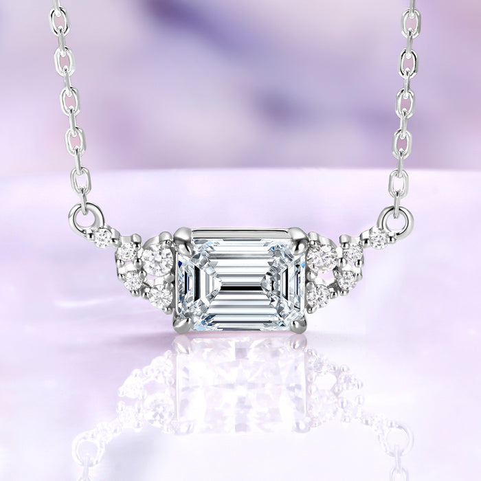 Emerald cut moissanite necklace in sterling silver, 6x8mm center stone set east-west with round moissanite accents