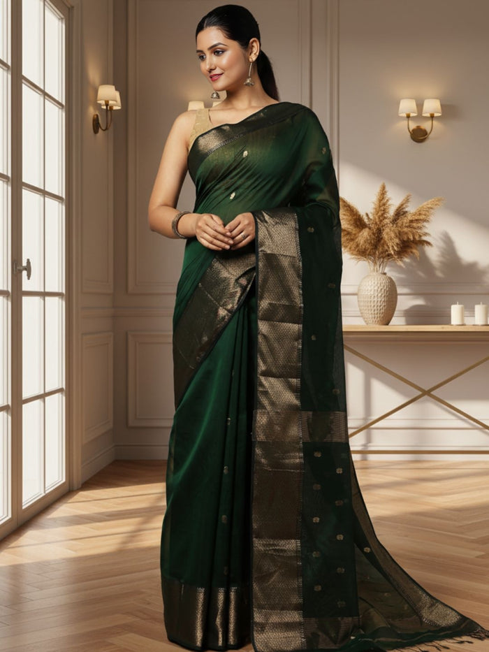 Dark emerald green Maheshwari silk saree with a semi-sheer body, small gold buti and metallic gold borders, handwoven in Maheshwar