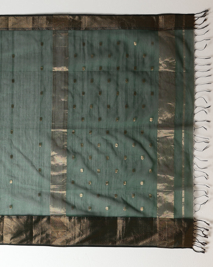 Dark emerald green Maheshwari silk saree with a semi-sheer body, small gold buti and metallic gold borders, handwoven in Maheshwar