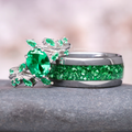 Emerald Leaf Couples Ring Set featuring a polished silver band with crushed emerald inlay and an intricate leaf-inspired ring with a pear-shaped emerald by Aquamarise.