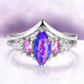 Emerie Blue Fire Opal & Pink Sapphire Ring Set in Sterling Silver featuring a marquise blue fire opal center flanked by oval pink sapphires and sparkling white accents, crafted by Aquamarise from nature and fantasy-inspired collections.