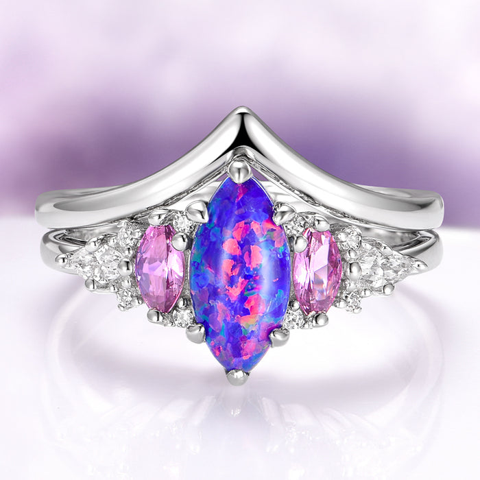 Emerie Blue Fire Opal & Pink Sapphire Ring Set in Sterling Silver featuring a marquise blue fire opal center flanked by oval pink sapphires and sparkling white accents, crafted by Aquamarise from nature and fantasy-inspired collections.