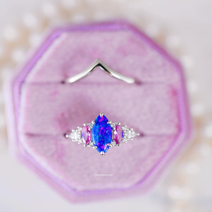 Emerie Blue Fire Opal & Pink Sapphire Ring Set in Sterling Silver featuring a marquise blue fire opal center flanked by vibrant pink sapphires and sparkling white stones, crafted by Aquamarise from nature-inspired collections.