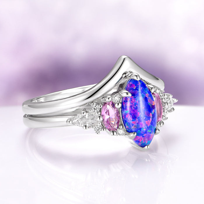 Emerie Blue Fire Opal & Pink Sapphire Ring Set in Sterling Silver featuring a marquise blue fire opal center stone accented by oval pink sapphires and delicate white stones, crafted by Aquamarise from nature-inspired collections.