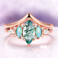 Emerie Moss Agate & Opalescent Sapphire Engagement Ring Set in 14K Solid Rose Gold featuring a marquise moss agate center flanked by opalescent sapphires and sparkling diamonds, crafted by Aquamarise Gold from nature-inspired and birthstone collections.