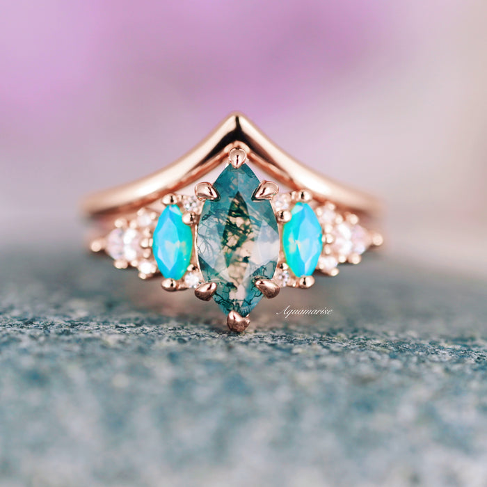 Emerie Marquise Cut Moss Agate & Opalescent Sapphire Ring Set in 14K Rose Gold Vermeil featuring a marquise moss agate center, accented with vibrant opalescent sapphires and diamonds, crafted by Aquamarise from nature-inspired collections.